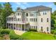 Rear exterior of the home with a spacious balcony, well-manicured lawn, and decorative hedges at 4720 Cliffside Ct, Marietta, GA 30067