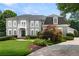 Front exterior of home with manicured lawn, stone driveway, and symmetrical landscaping at 4720 Cliffside Ct, Marietta, GA 30067