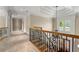 Bright hallway featuring hardwood stairs, wrought iron railing, chandelier, and access to a staircase at 4720 Cliffside Ct, Marietta, GA 30067