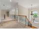 Bright hallway featuring hardwood stairs, wrought iron railing, chandelier, and an arch window at 4720 Cliffside Ct, Marietta, GA 30067