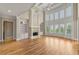 Bright living room features a fireplace, soaring ceilings, large windows, and elegant built-in shelving at 4720 Cliffside Ct, Marietta, GA 30067