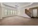 Spacious living room with large windows, tray ceiling, and access to staircase at 4720 Cliffside Ct, Marietta, GA 30067