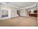 Expansive living room with carpet, tray ceiling, access to a bar, and stairway at 4720 Cliffside Ct, Marietta, GA 30067