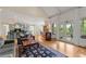 Open living room and kitchen with hardwood floors, fireplace, and access to the sunroom at 4720 Cliffside Ct, Marietta, GA 30067