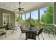 Screened-in porch with seating, a table, a ceiling fan, and a view of the surrounding trees at 4720 Cliffside Ct, Marietta, GA 30067