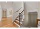 Elegant staircase with decorative wrought iron railing and wood steps leading to the upper level at 4720 Cliffside Ct, Marietta, GA 30067