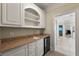 Convenient wet bar with custom cabinets, sink, and beverage center, perfect for entertaining at 4720 Cliffside Ct, Marietta, GA 30067