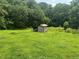 Large grassy yard featuring a shed structure at 547 Morningside Dr, Lawrenceville, GA 30043