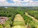 Beautiful aerial view showcases the neighborhood's golf course, tennis courts, and landscape at 921 Laurel Crest Dr, Woodstock, GA 30189