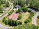 Aerial view showcasing the community's tennis courts, playground, and pool area at 921 Laurel Crest Dr, Woodstock, GA 30189