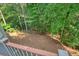 Beautiful, tranquil wooded backyard with lush foliage, as seen from an elevated deck at 921 Laurel Crest Dr, Woodstock, GA 30189