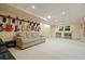 Large basement features a sofa, desk and guitar rack at 921 Laurel Crest Dr, Woodstock, GA 30189