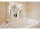 Luxury bathroom featuring a soaking tub and unique wallpaper at 921 Laurel Crest Dr, Woodstock, GA 30189