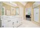 Bright bathroom features a white vanity and a glass-enclosed shower with tile surround at 921 Laurel Crest Dr, Woodstock, GA 30189