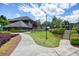 A beautiful community clubhouse is surrounded by lush greenery, a stone wall, and a well-maintained landscape at 921 Laurel Crest Dr, Woodstock, GA 30189