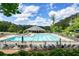 Large community pool with lots of lounge chairs and a covered picnic pavilion with mature shade trees at 921 Laurel Crest Dr, Woodstock, GA 30189