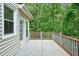 Outdoor deck with railing and French door entry to the house, nestled among the trees at 921 Laurel Crest Dr, Woodstock, GA 30189