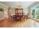 Elegant dining room with hardwood floors, a large window, and a decorative chandelier at 921 Laurel Crest Dr, Woodstock, GA 30189