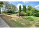 Well manicured entrance to Longwood is marked with a sign surrounded by grass and shrubbery at 921 Laurel Crest Dr, Woodstock, GA 30189