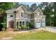 Traditional brick home featuring an attached two car garage and professional landscaping at 921 Laurel Crest Dr, Woodstock, GA 30189