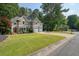 Charming two-story brick home with a well-manicured lawn and three-car garage at 921 Laurel Crest Dr, Woodstock, GA 30189