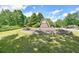 Stone monument sign for the golf club with a decorative rock and mulch landscaped bed at 921 Laurel Crest Dr, Woodstock, GA 30189