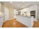 Modern kitchen with white cabinets, stainless steel appliances, and hardwood flooring at 921 Laurel Crest Dr, Woodstock, GA 30189