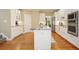Stylish kitchen featuring white cabinets, granite countertops, and stainless steel appliances at 921 Laurel Crest Dr, Woodstock, GA 30189