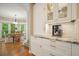 Well-lit kitchen area with white cabinets, granite countertops, and modern appliances at 921 Laurel Crest Dr, Woodstock, GA 30189