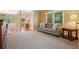 Inviting living room featuring plush carpeting, neutral tones, and a view into the foyer at 921 Laurel Crest Dr, Woodstock, GA 30189