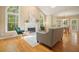 Open-concept living room featuring tall windows, a fireplace, and hardwood floors at 921 Laurel Crest Dr, Woodstock, GA 30189