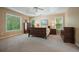 Comfortable main bedroom with neutral tones, natural light and plush carpet at 921 Laurel Crest Dr, Woodstock, GA 30189