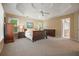 Spacious main bedroom showcasing a tray ceiling and plush carpet at 921 Laurel Crest Dr, Woodstock, GA 30189