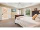 Cozy main bedroom featuring a tray ceiling and plush carpet at 921 Laurel Crest Dr, Woodstock, GA 30189