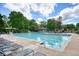 Spacious community pool surrounded by lounge chairs and greenery, offering a perfect spot for relaxation and recreation at 921 Laurel Crest Dr, Woodstock, GA 30189