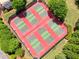 Aerial view of well-maintained community tennis courts surrounded by lush greenery at 921 Laurel Crest Dr, Woodstock, GA 30189