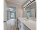 Bathroom featuring a large mirror, white cabinets, and modern finishes at 1758 N Springs Dr, Atlanta, GA 30338
