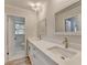 Bright bathroom features a double sink vanity with white cabinets and quartz counters at 1758 N Springs Dr, Atlanta, GA 30338