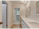 Bright bathroom features a double sink vanity with white cabinets and quartz counters at 1758 N Springs Dr, Atlanta, GA 30338