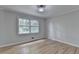 Bright bedroom with hardwood floors and a large window letting in natural light at 1758 N Springs Dr, Atlanta, GA 30338