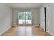 Neutral bedroom with hardwood floors and large window at 1758 N Springs Dr, Atlanta, GA 30338