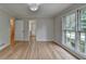 Neutral bedroom featuring hardwood floors, light-colored walls, and view into hallway at 1758 N Springs Dr, Atlanta, GA 30338