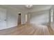 Bedroom featuring hardwood floors, modern lighting, and access to closet at 1758 N Springs Dr, Atlanta, GA 30338