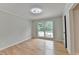 Bedroom with modern lighting, neutral walls, and large window at 1758 N Springs Dr, Atlanta, GA 30338