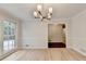 Dining room with hardwood floors, large windows, neutral walls, and classic trim at 1758 N Springs Dr, Atlanta, GA 30338