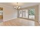 Bright dining room featuring hardwood floors, large windows, and a stylish chandelier at 1758 N Springs Dr, Atlanta, GA 30338