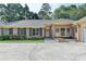 Charming brick home featuring a symmetrical facade, lush greenery, and a spacious driveway at 1758 N Springs Dr, Atlanta, GA 30338