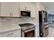 Close-up of kitchen with stainless steel appliances and sleek white countertops at 1758 N Springs Dr, Atlanta, GA 30338