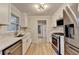 Bright kitchen featuring white cabinets, stainless steel appliances, and hardwood flooring at 1758 N Springs Dr, Atlanta, GA 30338