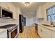 Bright kitchen with stainless steel appliances, white cabinets, and hardwood floors at 1758 N Springs Dr, Atlanta, GA 30338